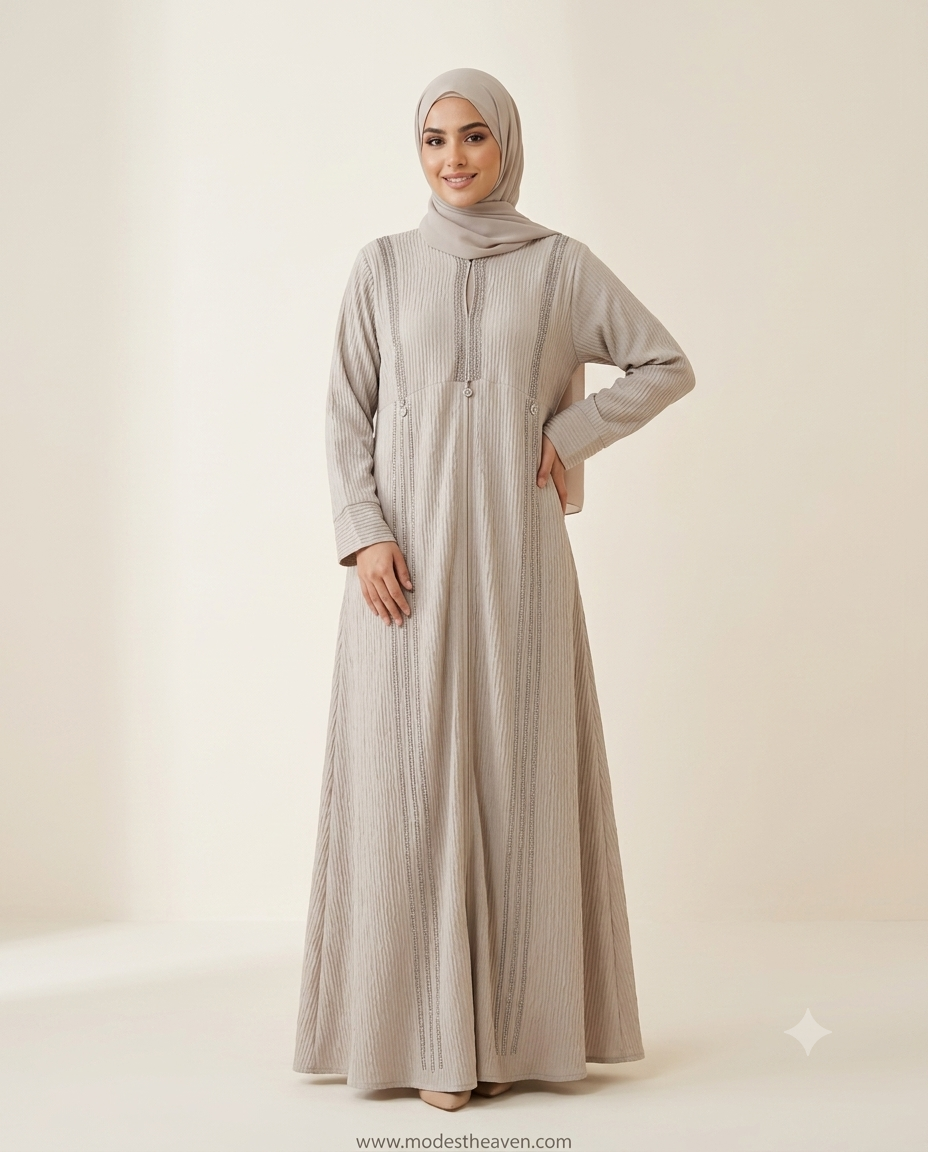 Woman wearing beige ribbed textured abaya with rhinestone embellished panels and hijab
