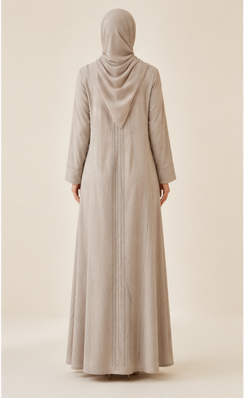 Woman wearing beige ribbed textured abaya with rhinestone embellished panels and hijab