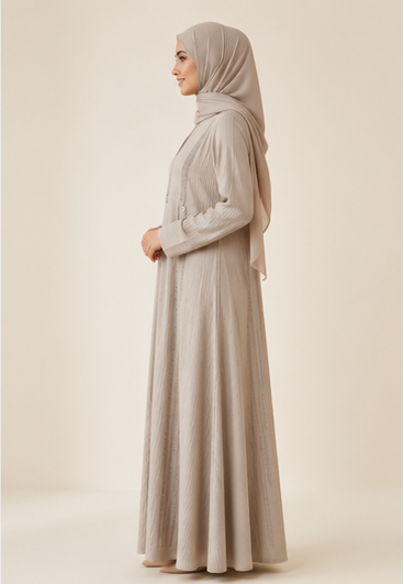Woman wearing beige ribbed textured abaya with rhinestone embellished panels and hijab