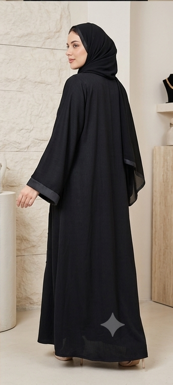 Woman wearing black beaded button-down abaya with satin trim hijab, full-length front view