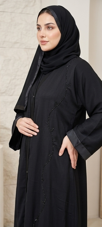 Woman wearing black beaded button-down abaya with satin trim hijab, full-length front view