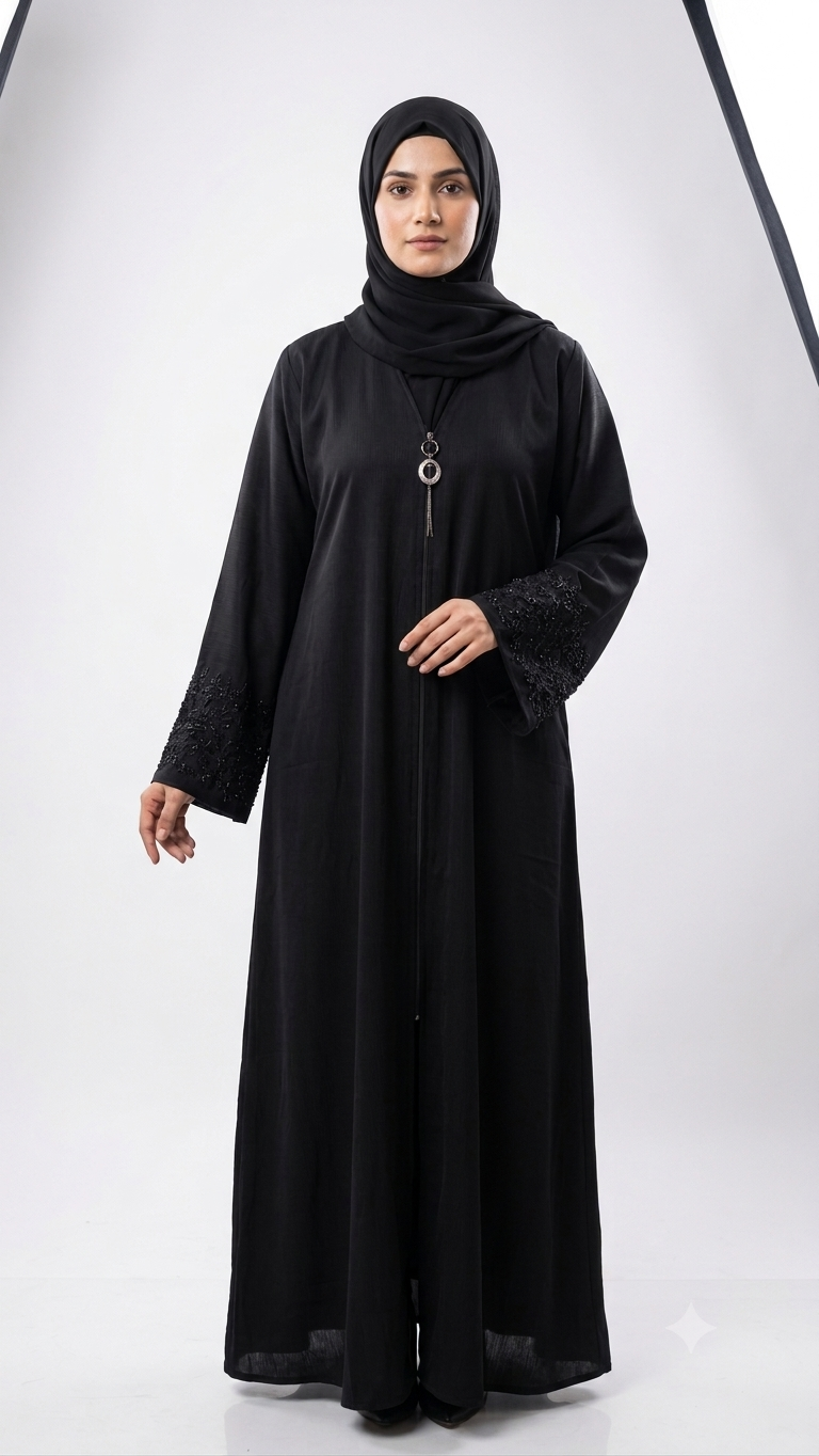 Woman wearing black abaya with beaded lace cuffs and pendant necklace, matching hijab, front view