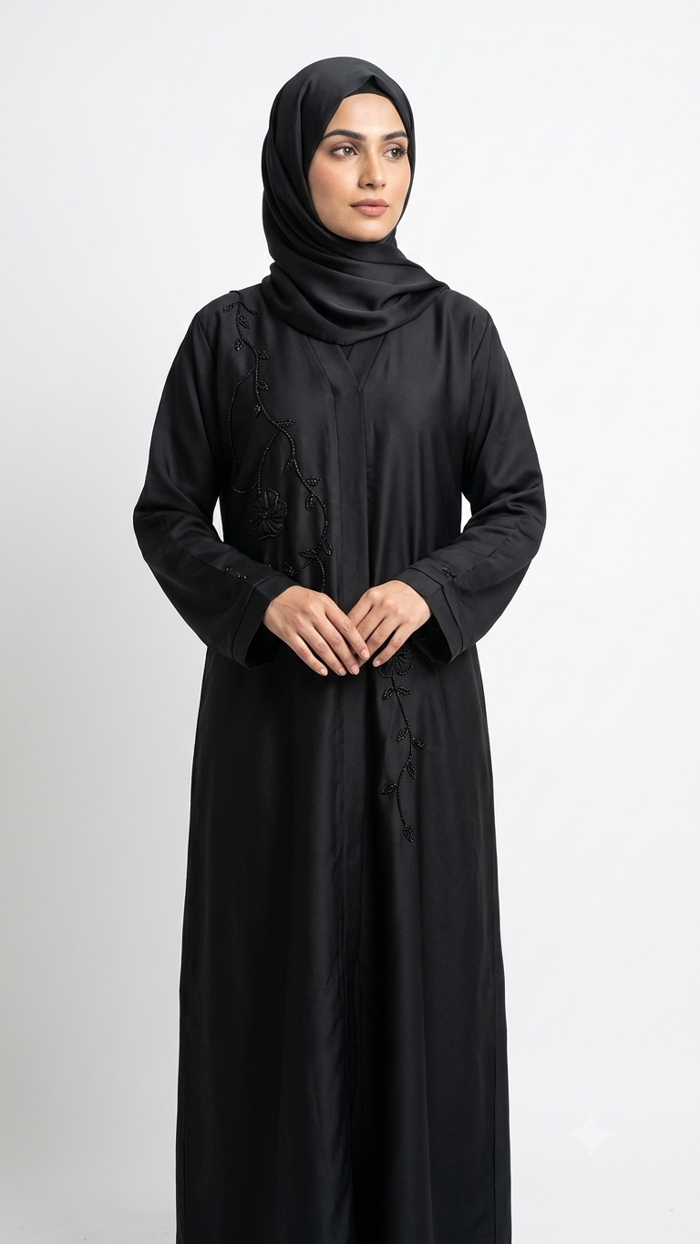 Woman wearing black abaya with beaded vine and flower embroidery, matching hijab, front view