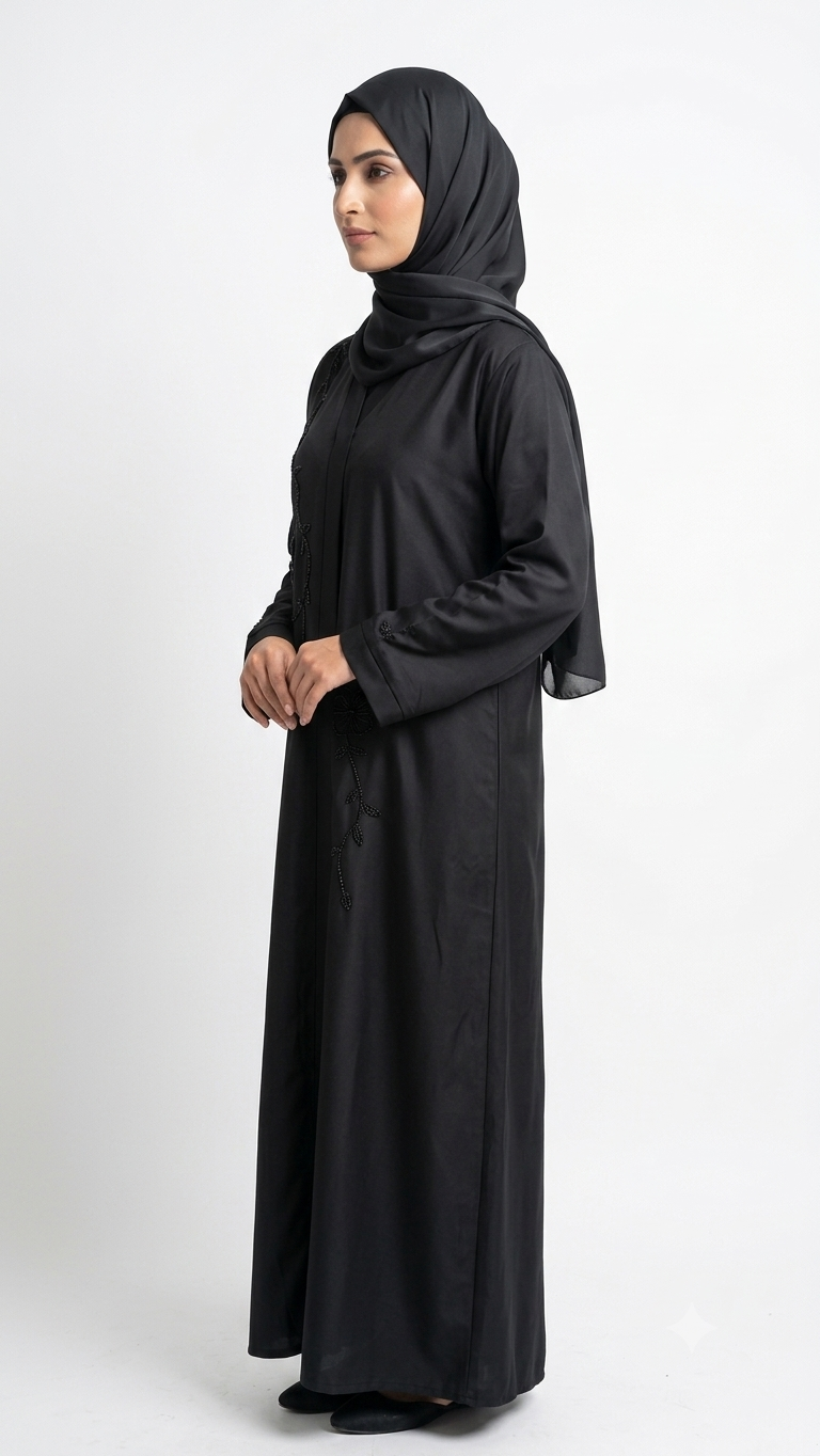 Woman wearing black abaya with beaded vine and flower embroidery, matching hijab, side view