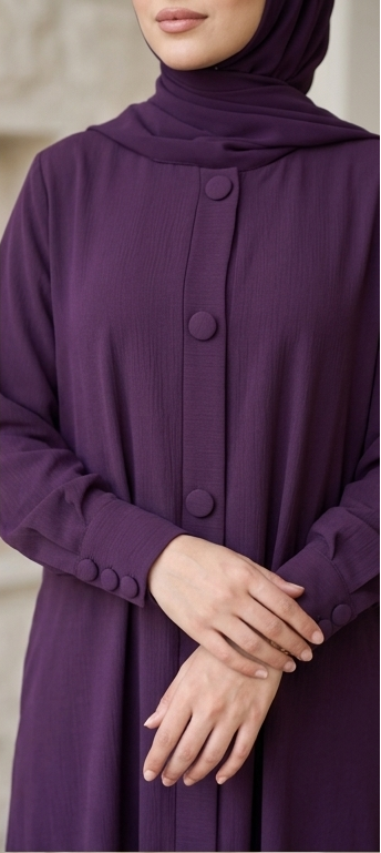 Close-up of covered button detailing on front placket and cuff of deep purple abaya