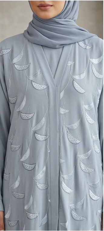 Woman wearing dusty grey feather embroidered abaya with matching hijab, full-length 