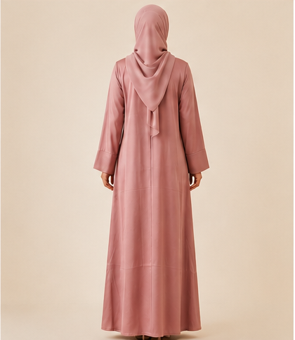 Woman wearing a dusty rose front-pleated abaya with matching chiffon hijab, full-length front view