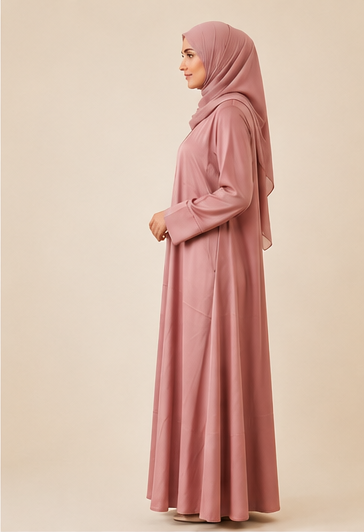 Woman wearing a dusty rose front-pleated abaya with matching chiffon hijab, full-length front view