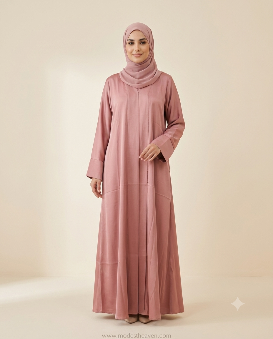 Woman wearing a dusty rose front-pleated abaya with matching chiffon hijab, full-length front view