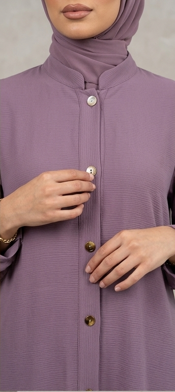 Woman wearing mauve purple button-down abaya with mandarin collar and matching hijab, full-length