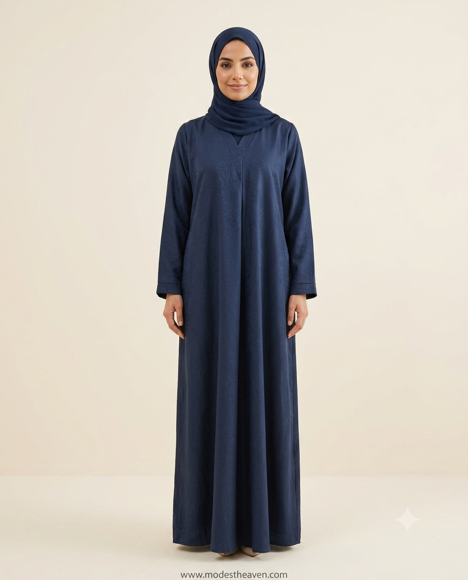 Woman wearing navy blue jacquard closed abaya with matching hijab full length front view
