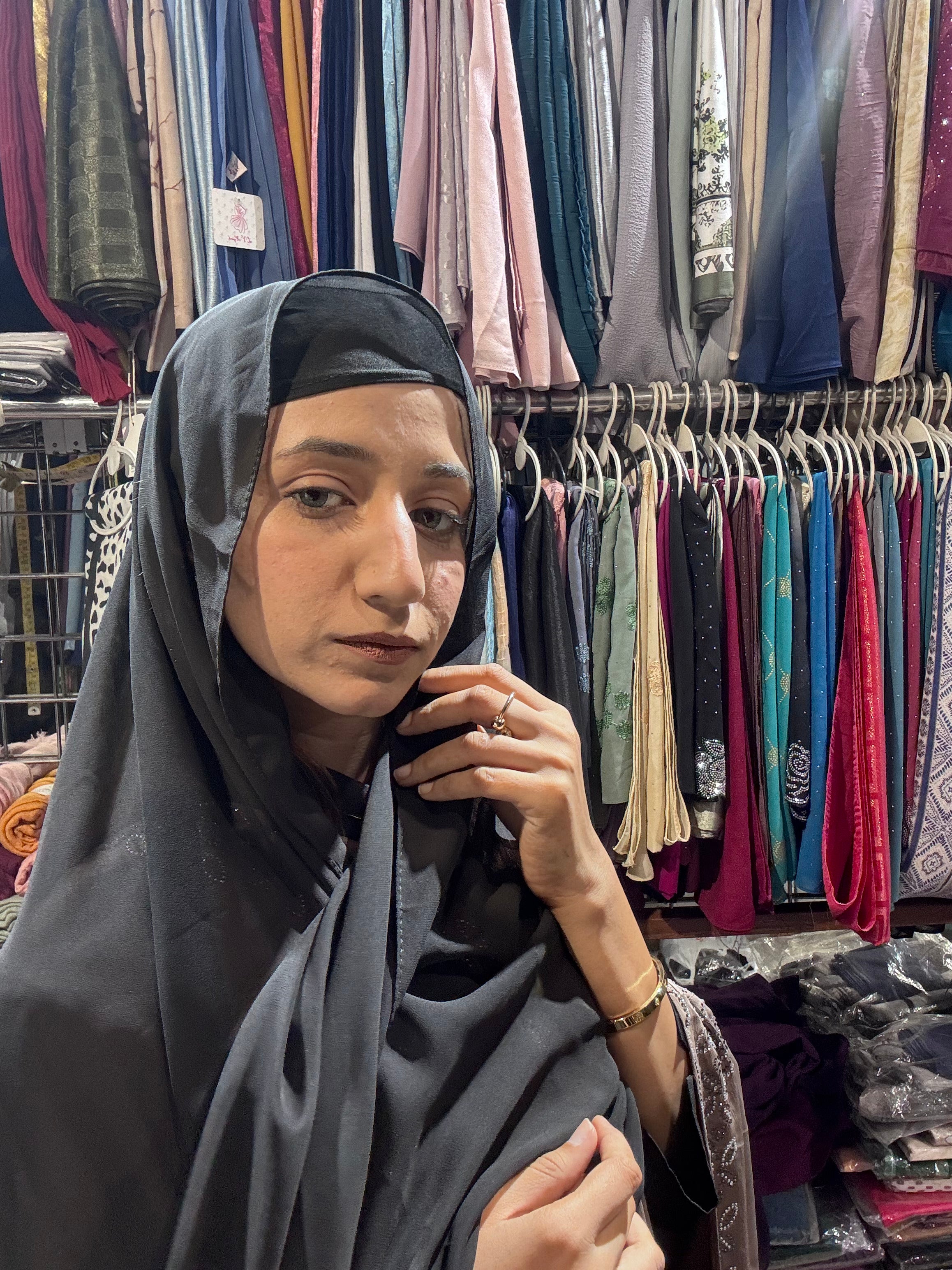 Woman wearing charcoal grey premium chiffon hijab scarf in clothing store