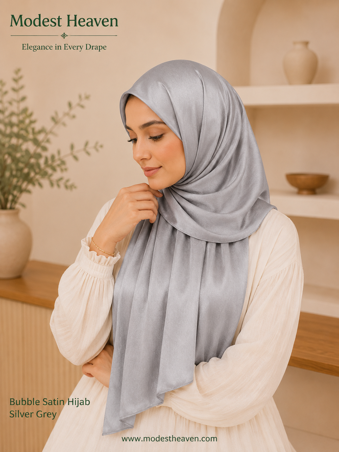 Woman wearing silver grey premium bubble satin hijab, seated portrait view