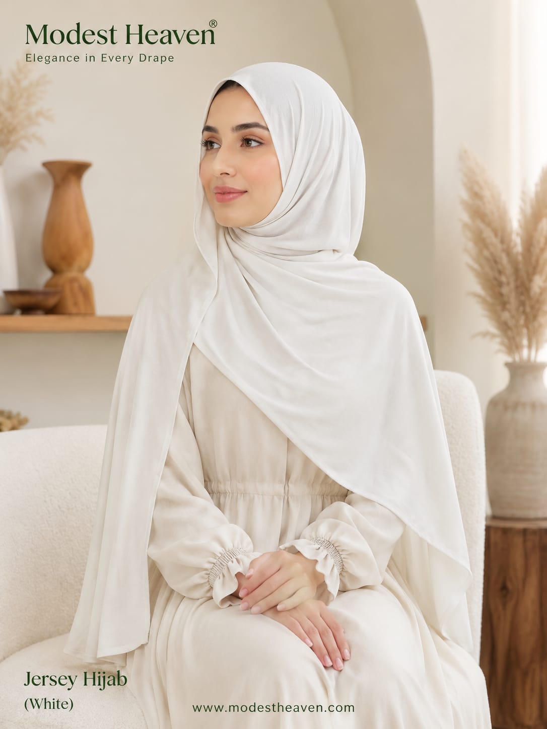 Woman wearing white premium jersey hijab, seated portrait view